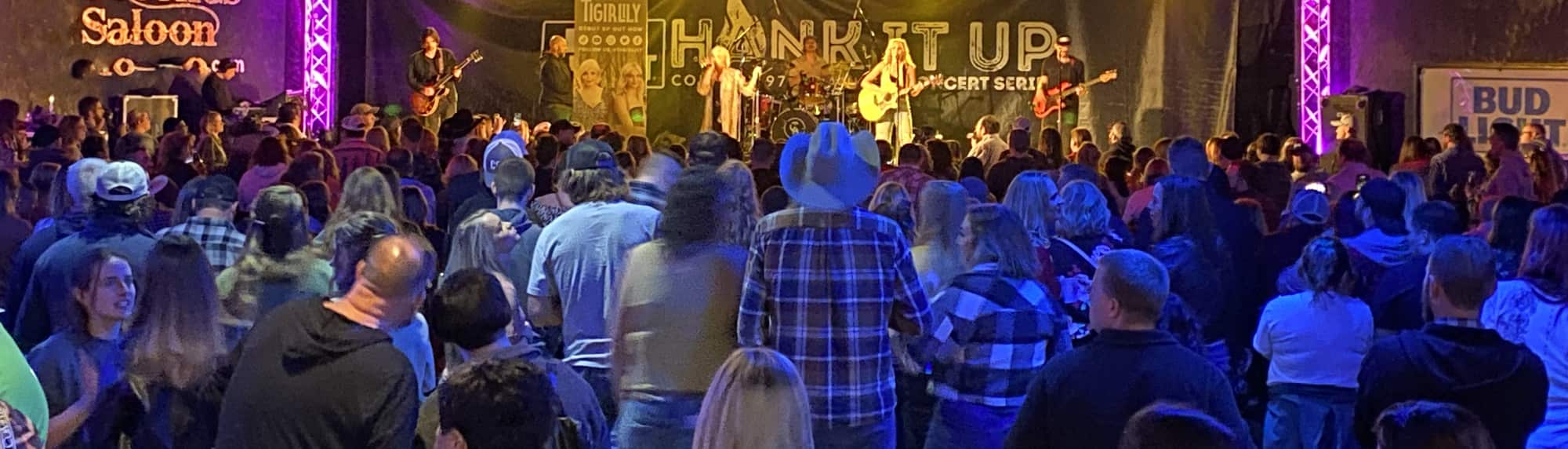 country concert with fans wearing cowboy hats Manhattan