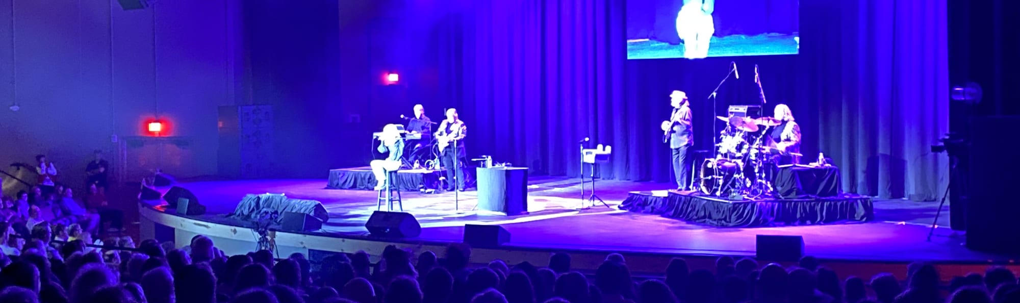 signer on stage in chair washed out by the lights Manhattan